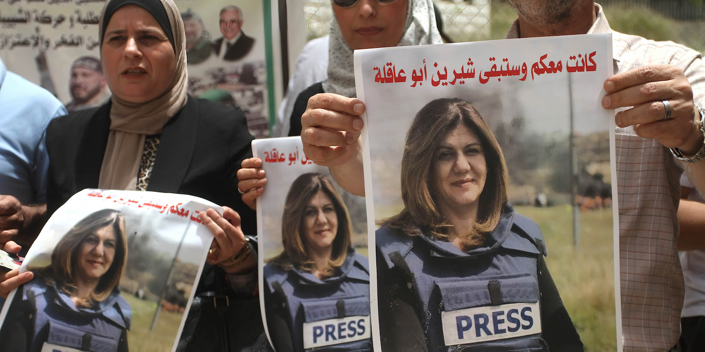 NABLUS, WEST BANK, PALESTINE - 2022/05/14: Palestinian students hold pictures of Al Jazeera reporter Shireen Abu Akleh during a protest condemning her murder at the Al-Quds Open University in the city of Nablus in the occupied West Bank. (Photo by Nasser Ishtayeh/SOPA Images/LightRocket via Getty Images)