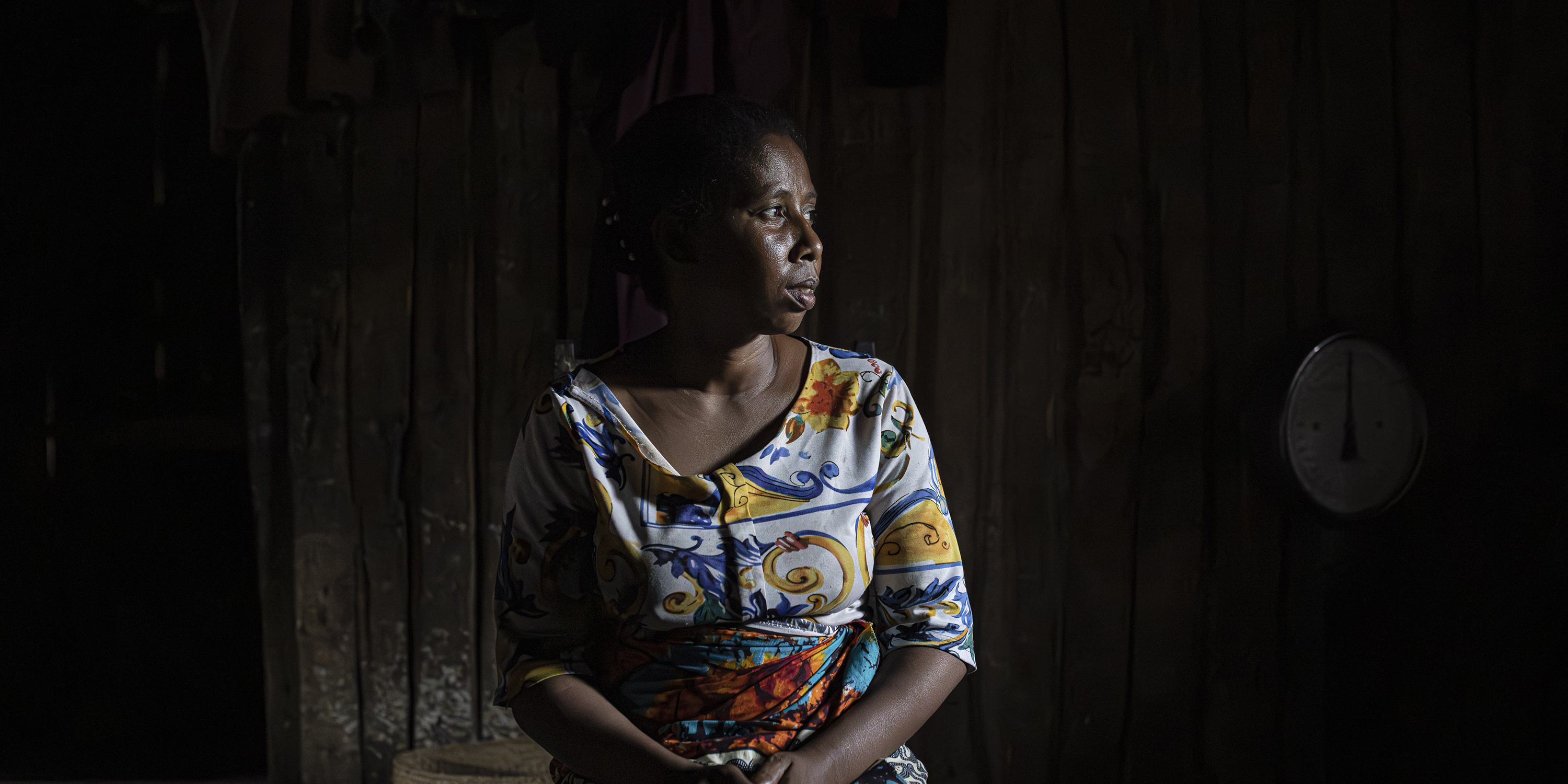 Razafihanta Flogone, 38, poses for a portrait inside her home in Ambinanibe in Fort-Dauphin, Madagascar, on July 11, 2023. Her husband Randriamanjaka Zeze used to fish where the port built by QMM is now located. They had to find new places to fish and she took on weaving to help support her family.