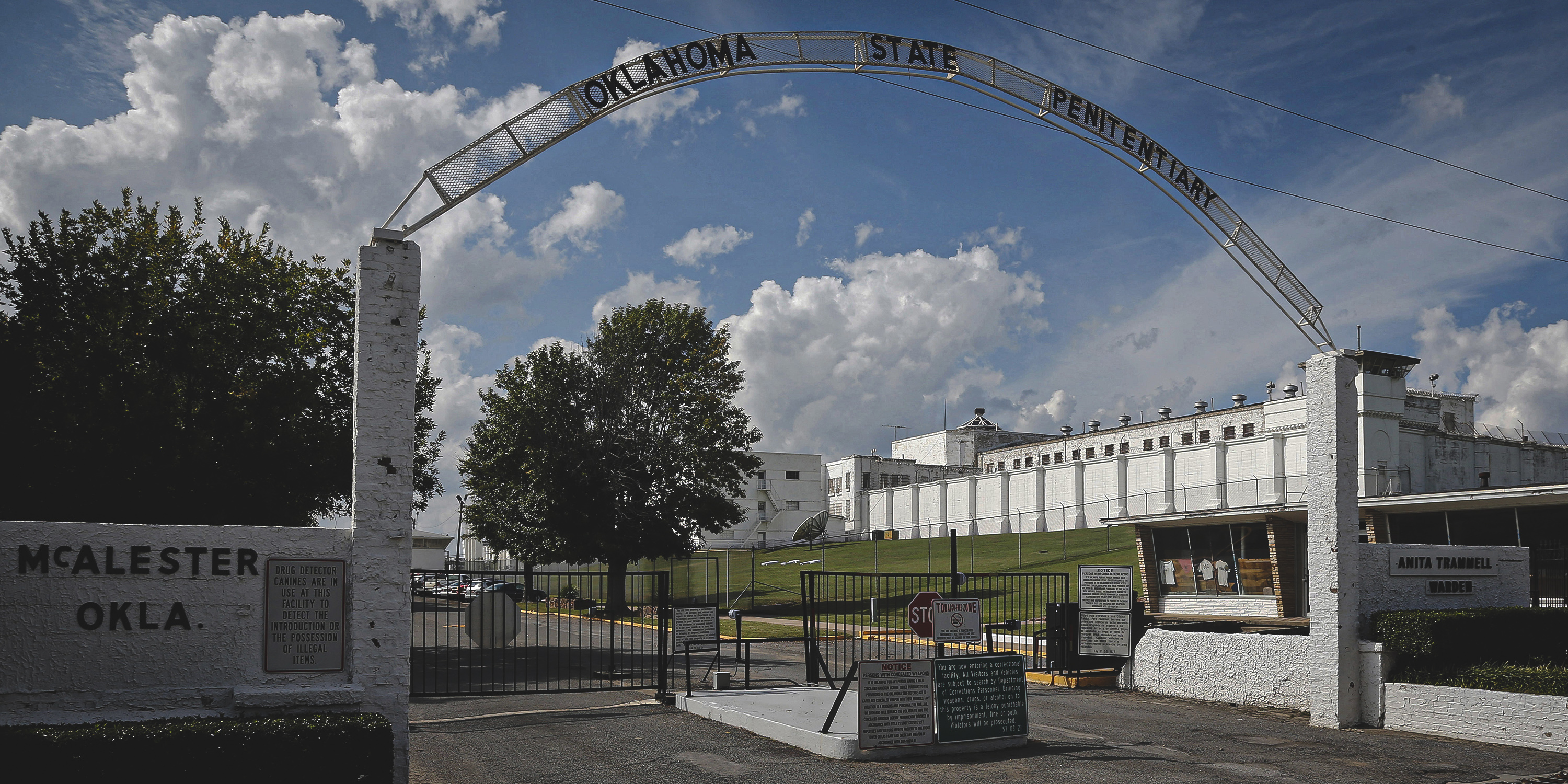 FILE - This Oct. 9, 2014, file photo shows the entrance to the Oklahoma State Penitentiary in McAlester, Okla. The Oklahoma Department of Corrections plans to move some of the 44 death row inmates housed at the prison's maximum-security H-Unit to another unit to give them more benefits and access to the outdoors. In a letter released Thursday, Oct. 3, 2019, from the agency's interim director to the American Civil Liberties Union of Oklahoma, the agency's interim Director Scott Crow says he plans to move "qualifying inmates" to another unit by the end of October.(AP Photo/Sue Ogrocki, File)