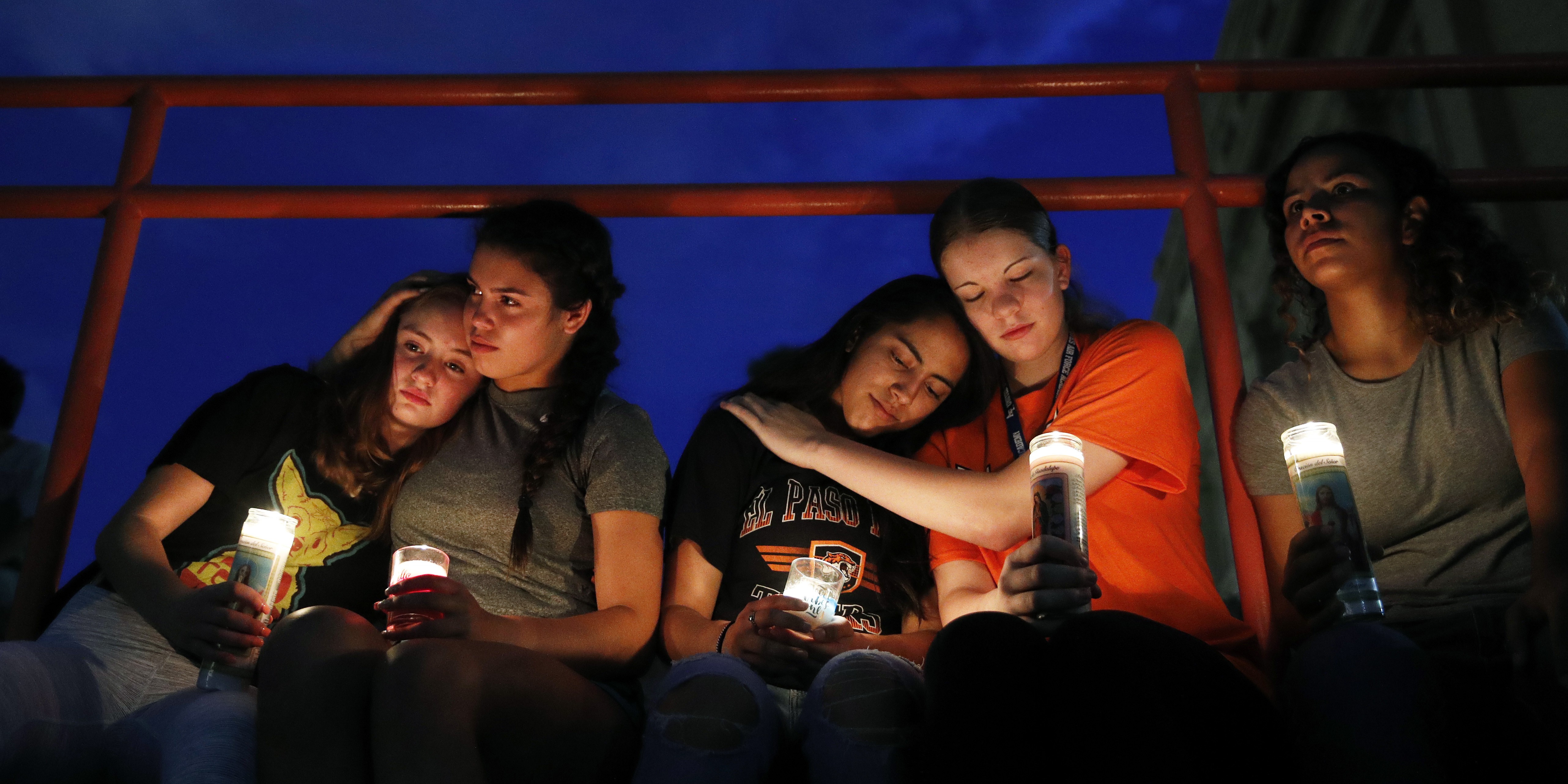 From left, Melody Stout, Hannah Payan, Aaliyah Alba, Sherie Gramlich and Laura Barrios comfort each other during a vigil for victims of the shooting Saturday, Aug. 3, 2019, in El Paso, Texas. A young gunman opened fire in an El Paso, Texas, shopping area during the busy back-to-school season, leaving multiple people dead and more than two dozen injured. (AP Photo/John Locher)