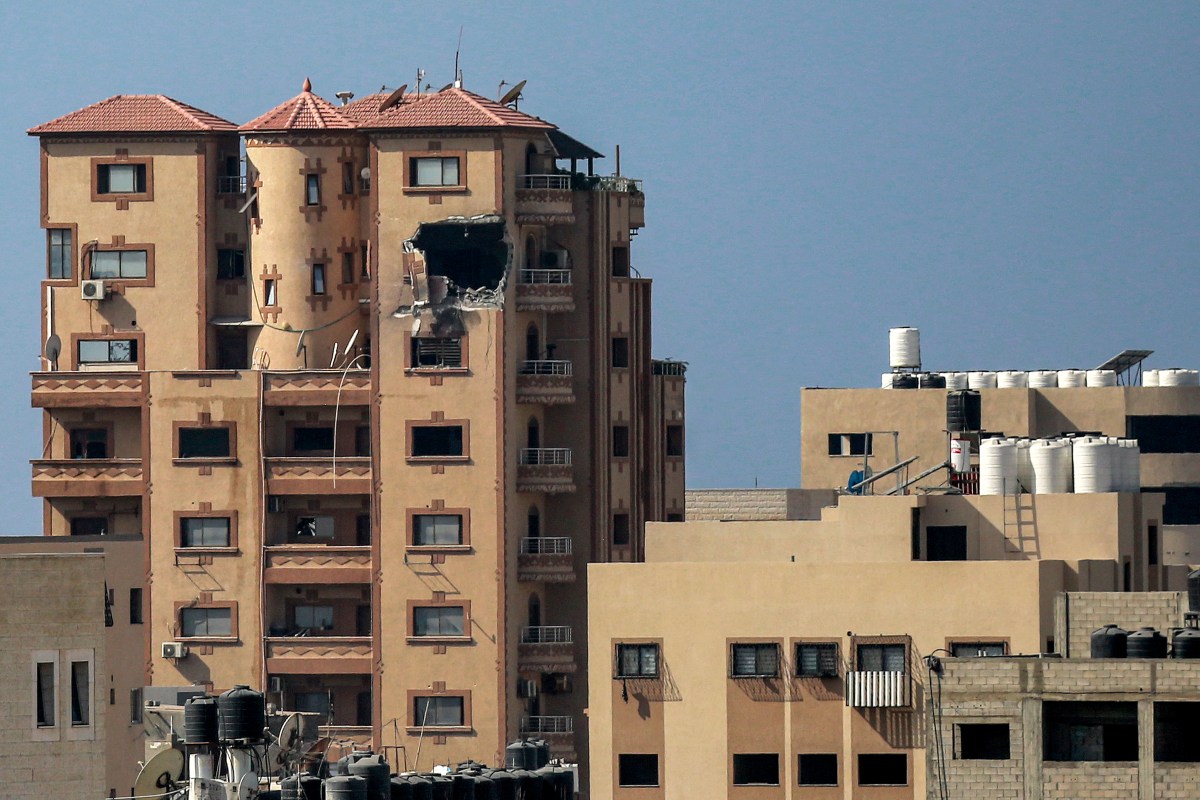 This picture taken on November 3, 2023 shows a gaping hole following a strike on the Hajji building, which houses several offices including those of Agence France Presse (AFP) news bureau in Gaza City amid the ongoing battles between Israel and the Palestinian group Hamas. (Photo by Bashar TALEB / AFP) / ?The erroneous mention[s] appearing in the metadata of this photo by Bashar TALEB has been modified in AFP systems in the following manner: [a strike] instead of [an Israeli strike]. Please immediately remove the erroneous mention[s] from all your online services and delete it (them) from your servers. If you have been authorized by AFP to distribute it (them) to third parties, please ensure that the same actions are carried out by them. Failure to promptly comply with these instructions will entail liability on your part for any continued or post notification usage. Therefore we thank you very much for all your attention and prompt action. We are sorry for the inconvenience this notification may cause and remain at your disposal for any further information you may require.?