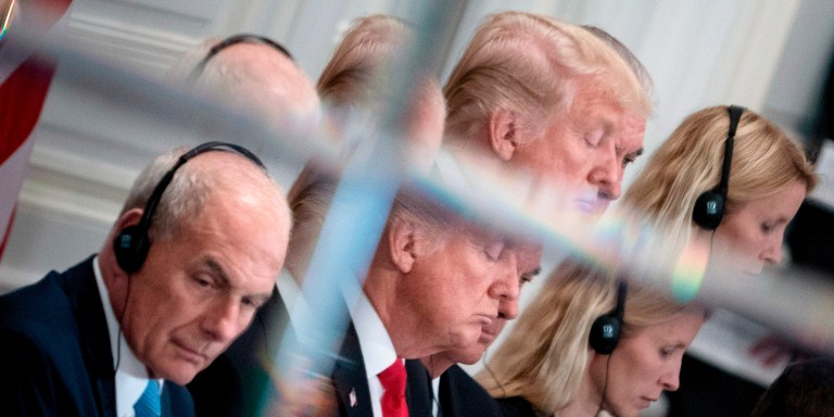 White House Chief of Staff John Kelly (L) and US President Donald Trump are seen in a mirror as they listen to opening statements before a luncheon with US and African leaders at the Palace Hotel during the 72nd United Nations General Assembly on September 20, 2017 in New York. / AFP PHOTO / Brendan Smialowski        (Photo credit should read BRENDAN SMIALOWSKI/AFP/Getty Images)