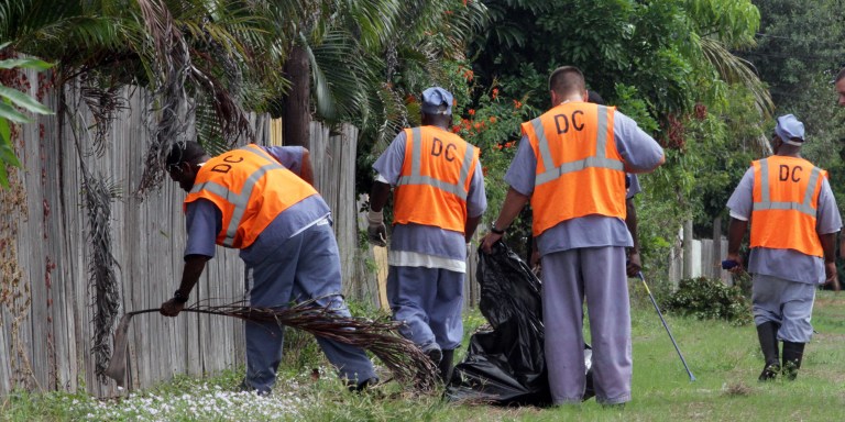 Nov. 18, 2013 - West Palm Beach, Florida, U.S. - Florida Dept. of Corrections work squad inmates clean a canal area in Greenacres on Monday, Nov. 19, 2013. Four Palm Beach County municipalities use prison inmates to do work ranging from mowing cemeteries to cleaning up trash and maintaining parks. Under contracts with the Florida Department of Corrections, the cities pay for the cost of transporting and guarding the inmate work crews, a deal that city officials say saves taxpayers money. Cities with inmate work programs are: Lake Worth, Greenacres, Wellington and Royal Palm Beach. (Credit Image: © Taylor Jones/The Palm Beach Post/ZUMAPRESS.com)