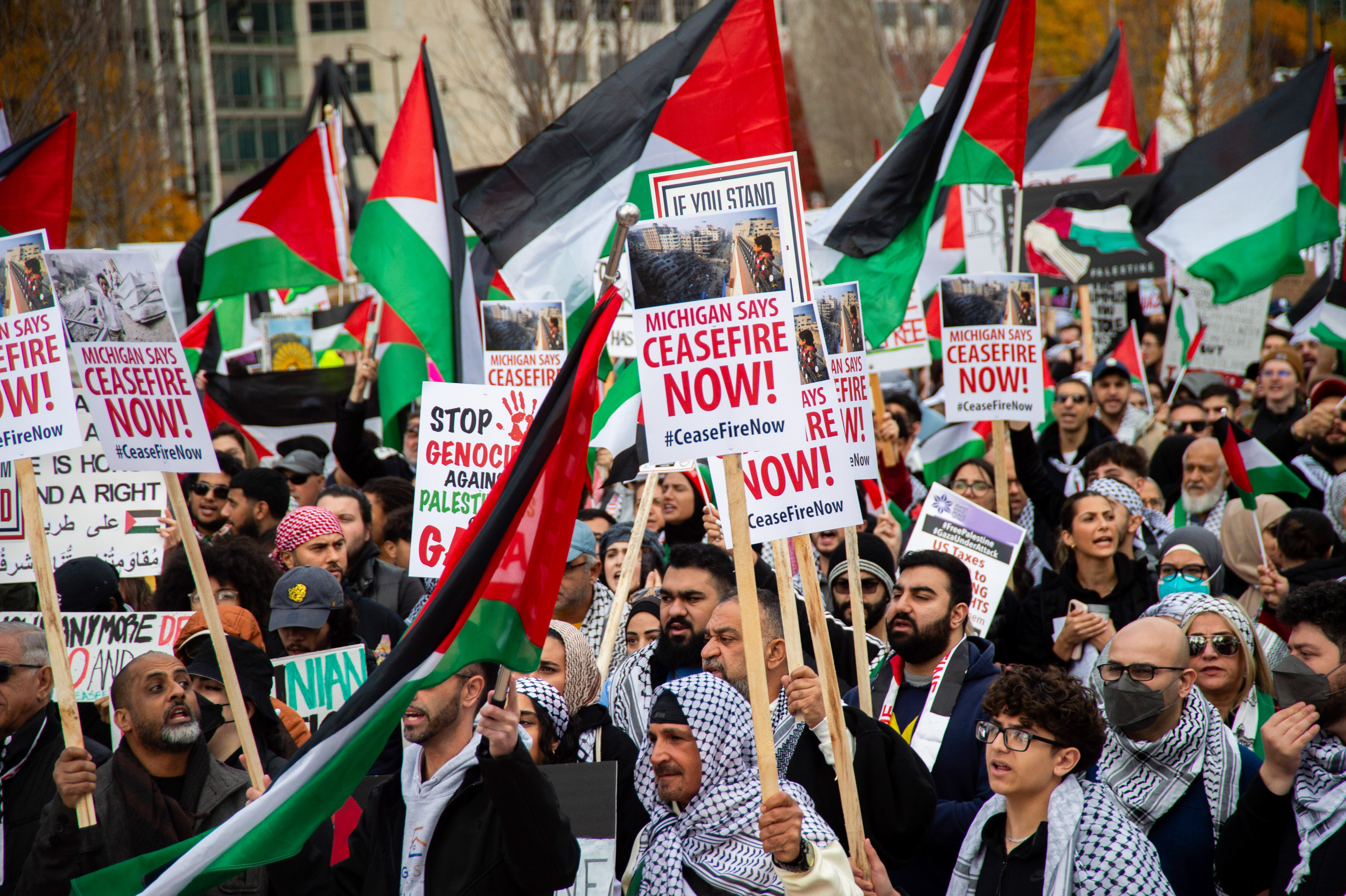 DETROIT, MICHIGAN, UNITED STATES - 2023/10/28: Protesters hold flags and placards expressing their opinion during a Cease Fire on Gaza rally. A massive gathering of over a thousand protesters from in and around Detroit attended the rally in solidarity with Palestine. The residents of Detroit and nearby communities have been organizing frequent rallies due to Israel's escalating bombardments and attacks on Gaza, which began after an attack by Palestinian militant group Hamas on Israel on October 7, 2023. Detroit is home to the largest Arab population in the United States, including many Palestinians. (Photo by Matthew Hatcher/SOPA Images/LightRocket via Getty Images)