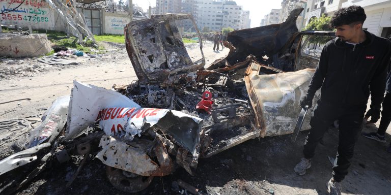 GAZA CITY, GAZA - FEBRUARY 10: A Palestinian man looks at the heavy damaged ambulance going to aid Rajab family, which was targeted by Israeli forces and became unusable, Tel al-Hawa neighborhood of Gaza City, Gaza on February 10, 2024. After the Israeli forces withdrew from the region, it was seen that an ambulance going to the region to help the 6-year-old Hind Rajab and five members of her family, who was shot in the Israeli attack, was also targeted by the Israeli forces. The Palestinian Red Crescent Society (PRCS) said six-year-old girl Hind Rajab, who was trapped in her family car after it came under Israeli army in Gaza City, was found dead after nearly two weeks of uncertainty. The non-profit in a statement late Friday said the bodies of the child, and two of its paramedics, Youssef Zeino and Ahmed Al-Madhoon, who went out on a mission to rescue the little girl on Jan. 29 had been found. (Photo by Dawoud Abo Alkas/Anadolu via Getty Images)