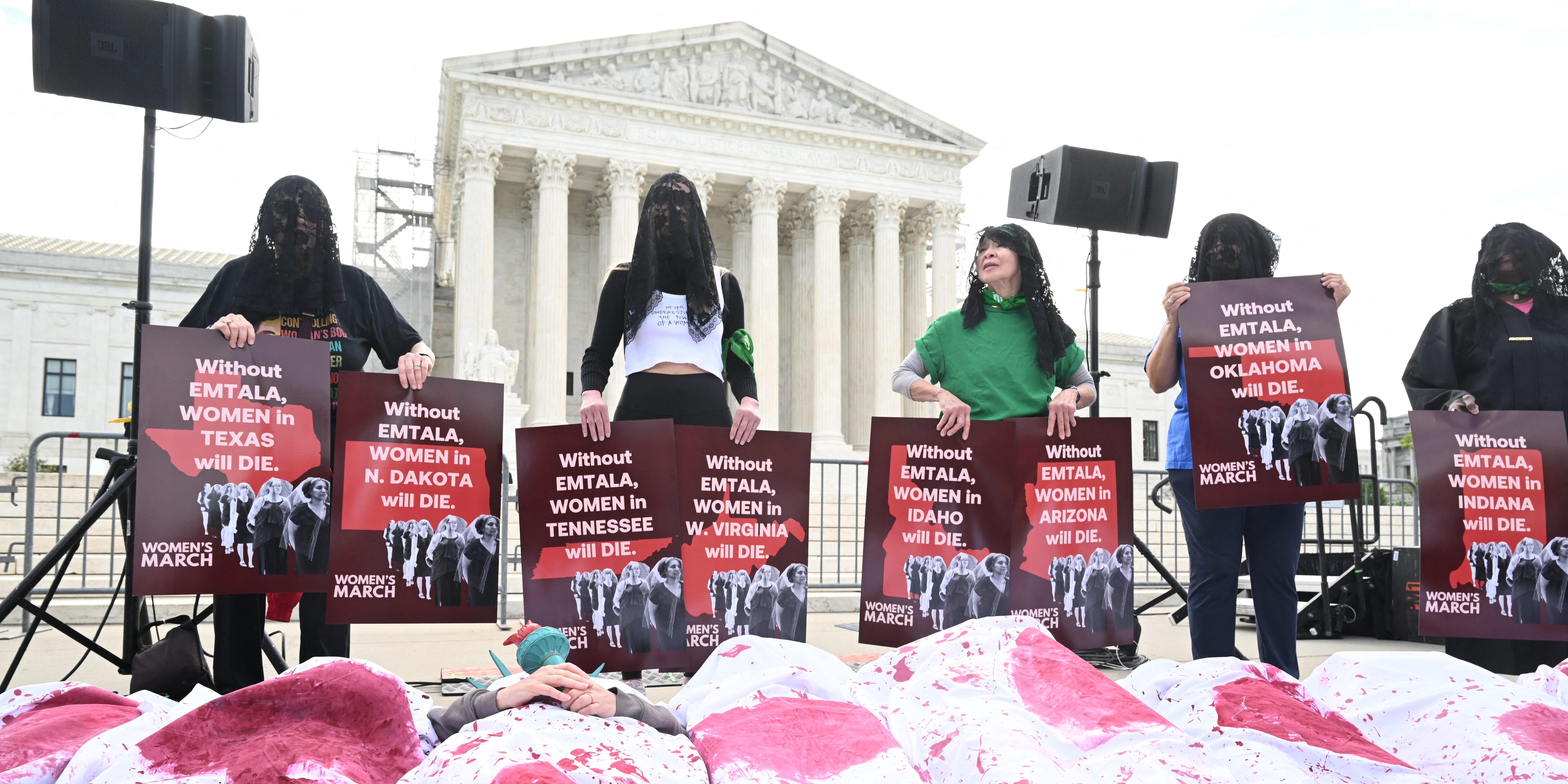 People participate in a "Die-In" to support "reproductive rights and emergency abortion care," outside the US Supreme Court as it hears arguments in the Moyle v. United States case, in Washington, DC, on April 24, 2024. The case deals with whether an Idaho abortion law conflicts with the federal Emergency Medical Treatment and Labor Act (EMTALA). (Photo by SAUL LOEB / AFP) (Photo by SAUL LOEB/AFP via Getty Images)