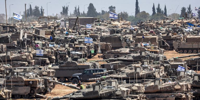 TOPSHOT - Israeli army main battle tanks and other military vehicles are positioned in southern Israel near the border with the Gaza Strip on May 9, 2024, amid the ongoing conflict in the Palestinian territory between Israel and the Hamas movement. (Photo by AHMAD GHARABLI / AFP) (Photo by AHMAD GHARABLI/AFP via Getty Images)