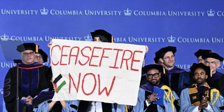 NEW YORK, UNITED STATES - MAY 13: Alumni of Columbia law school carry out silent pro-Palestinian protest with keffiyehs and banners, calling for ceasefire during their graduation ceremony in New York, United States on May 13, 2024. (Photo by Fatih Akta/Anadolu via Getty Images)