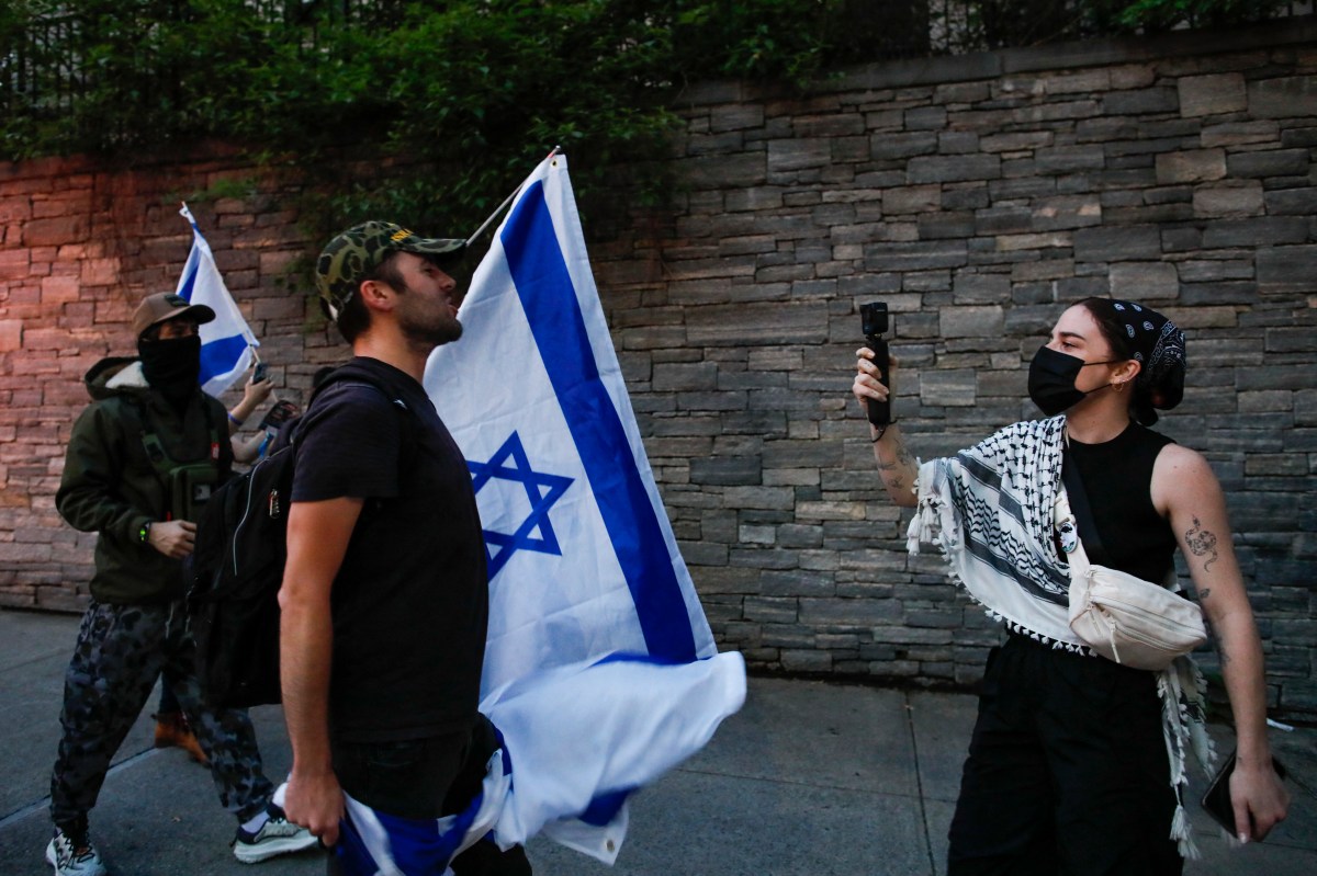 A pro-Palestinian protestor (R) argues with Pro-Israel protesters during a demonstration outside Columbia University, in New York City on May 23, 2024. (Photo by KENA BETANCUR / AFP) (Photo by KENA BETANCUR/AFP via Getty Images)