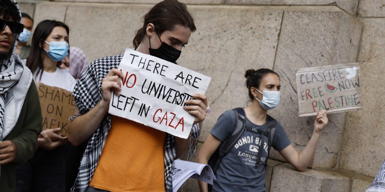 NEW YORK, NEW YORK - MAY 23: People with signs demonstrate near Columbia University on May 23, 2024 in New York City. Demonstrators gathered to protest against New York Mayor Eric Adams’s association with wealthy business owners and investors calling for they city's student protest encampments to be disbanded. Several of New York's prominent business owners reportedly offered political donations to Mayor Adams in an effort to influence public opinion towards Israel, while others suggested payments for private investigators to aid the NYPD in handling the student protesters, according to a Washington Post investigation of conversations made via on-line chats. According to City Hall, the NYPD did not use any donations in their handling of the protesters. (Photo by John Lamparski/Getty Images)