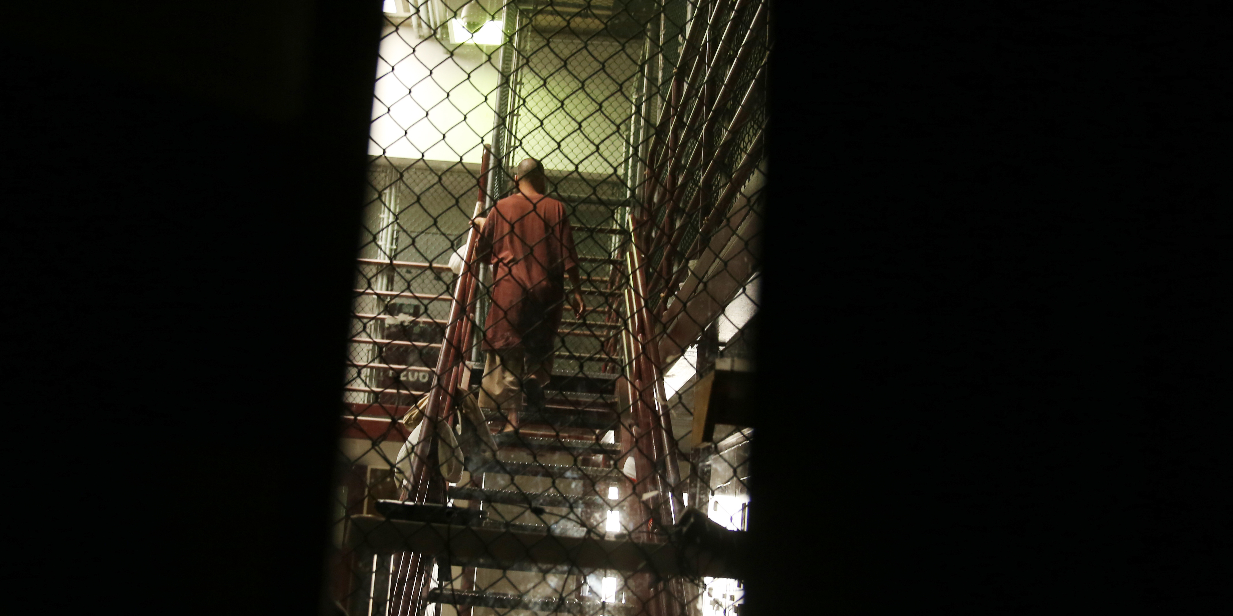 In this Feb. 2, 2016 photo, a detainee is seen going up the stairs at Camp 6 in the U.S. detention center at Guantanamo Bay, Cuba.  President Barack Obama’s administration is working to reduce the number of men held at Guantanamo as it prepares to ask Congress to close it down. (AP Photo/Ben Fox)