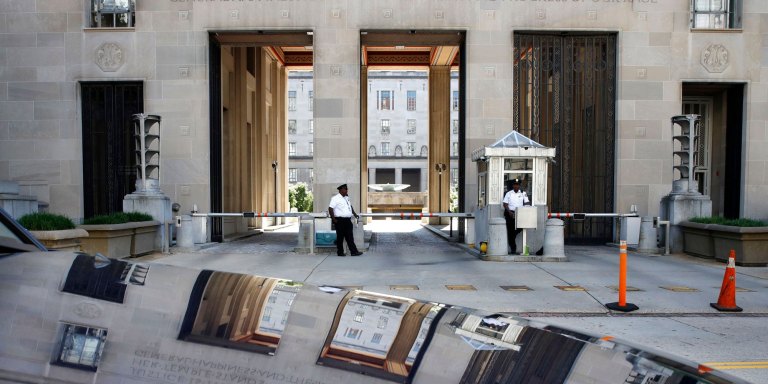 Mandatory Credit: Photo by Jacquelyn Martin/AP/REX/Shutterstock (9692541a)Security works at the Department of Justice as the building is reflected in the hood of a car, ahead of a group meeting about the Trump Russia probe in Washington. Among the people expected to meet at the request of President Donald Trump are House Permanent Select Committee on Intelligence Chairman Devin Nunes, House Committee on Oversight and Government Reform Chairman Trey Gowdy, FBI Director Christopher Wray, Director of National Intelligence Dan Coats, Principal Deputy Assistant Attorney General for the National Security Division Ed O'Callaghan, and White House Chief of Staff John KellyTrump Russia Probe, Washington, USA - 24 May 2018